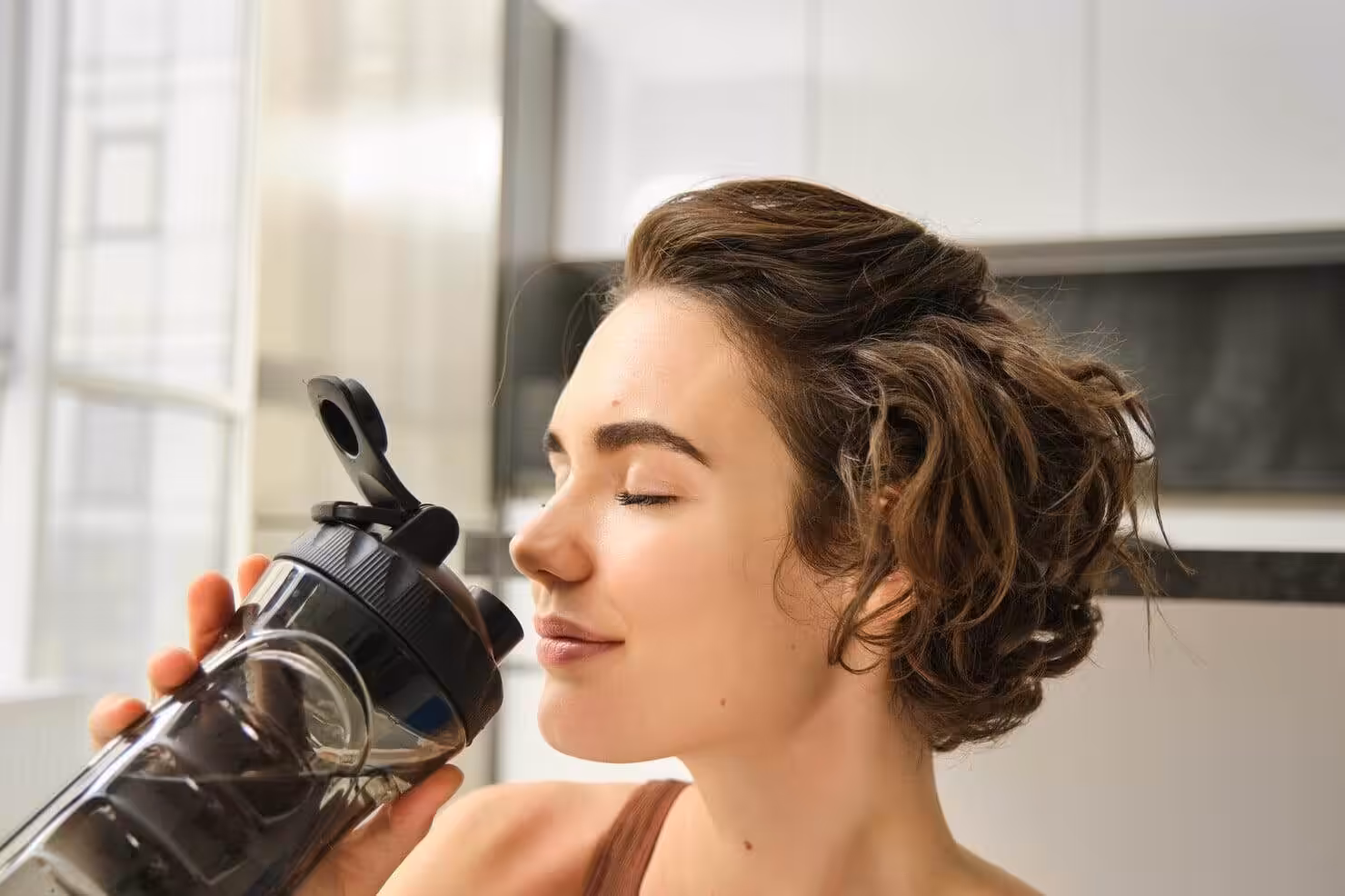 Woman drinking water for hydration and electrolyte restoration