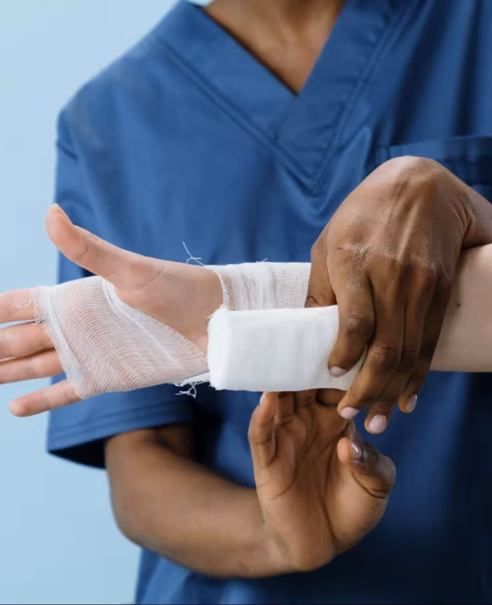 Healthcare professional bandaging patient's hand